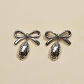 Silver Waterproof Football & Bow Stud Earrings